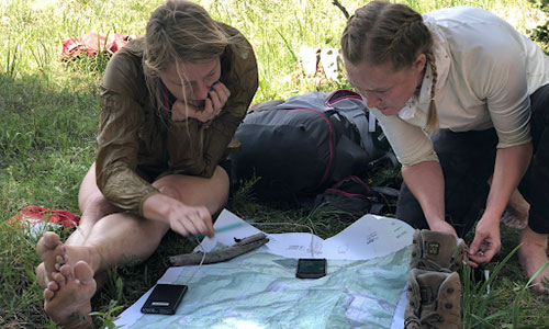 Students planning a route in the wilderness.